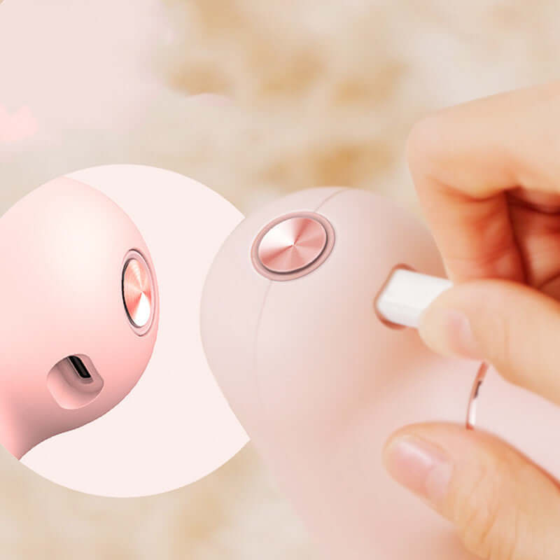Close-up of Mini USB Muscle Massage Gun Percussive charging port and button, showcasing its compact design.